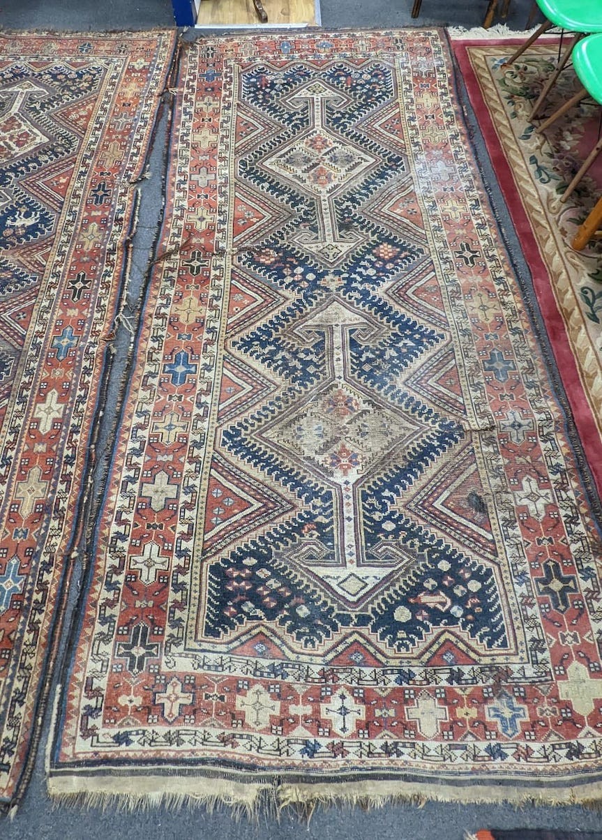 A pair of antique Caucasian blue ground rugs, 290 x 132cm